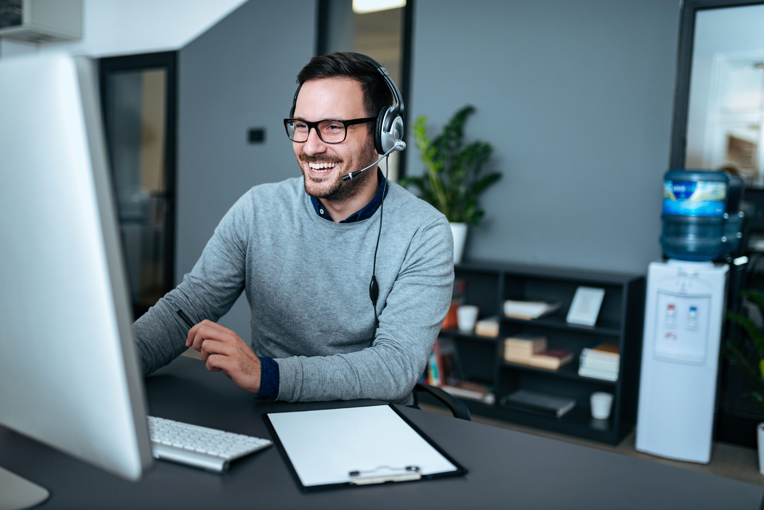 Smiling customer support agents wearing a headsets and helping customers