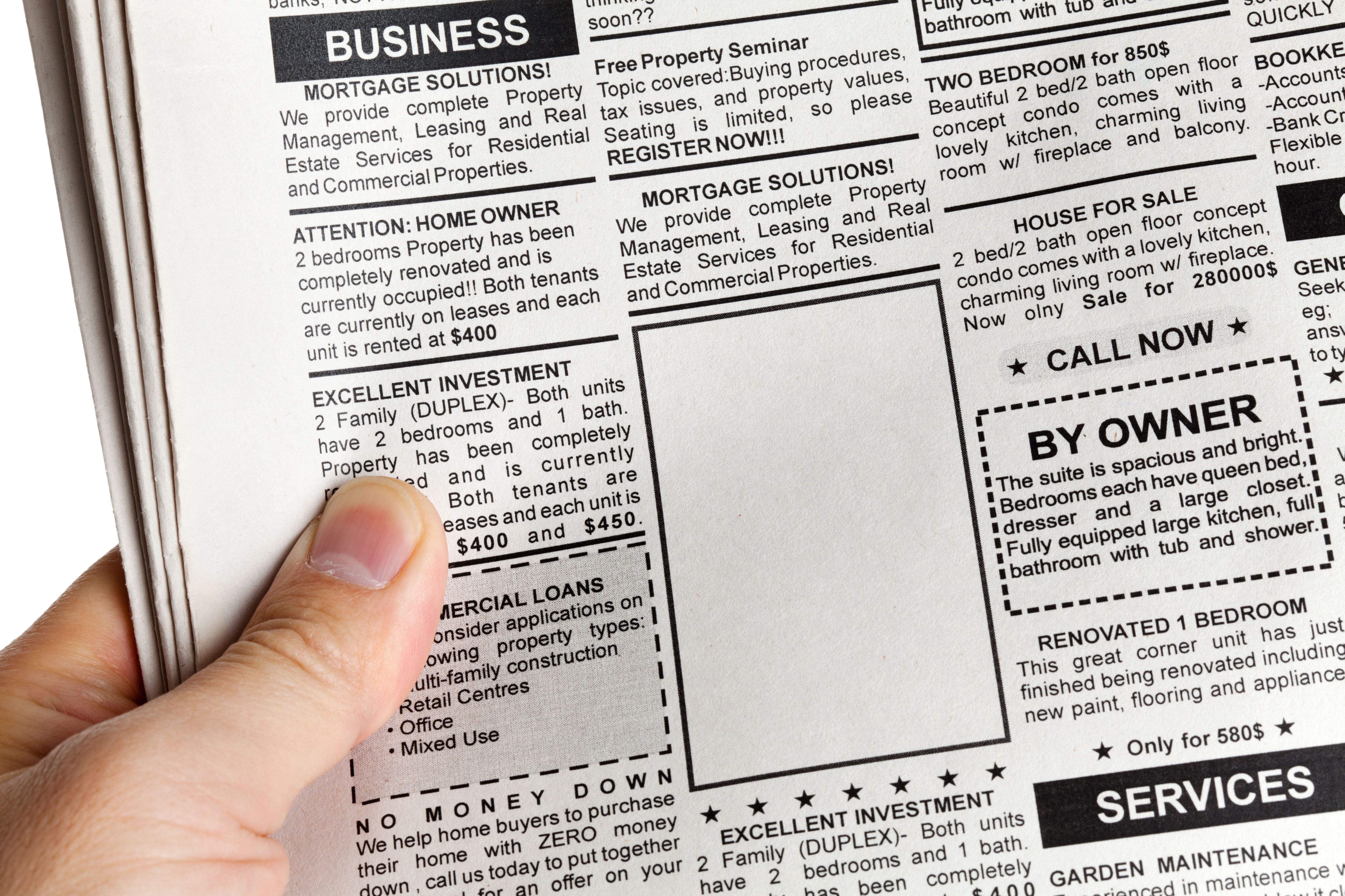 A magnifying glass resting on top of a printed 'Classifieds' newspaper section, magnifying ad categories like Business, Real Estate, and Careers to represent searching for opportunities.